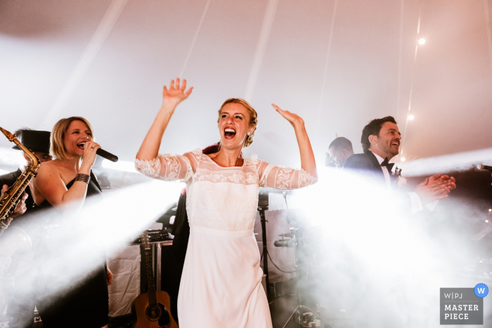 Photo by: <a href="https://www.wpja.com/contests/2019-v07/best-wedding-photographers/2502536">Karol Robache - Cucuron </a> The bride appears as if beams of light are bursting from her as she dances at her Provence wedding in this photo by a documentary-style PACA, France photographer.