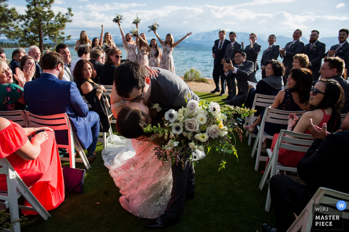 Photo by: <a href="https://www.wpja.com/contests/2019-v07/best-wedding-photographers/2502616">Matt Theilen - South Lake Tahoe California</a> Weddings Outdoors at Edgewood, Lake Tahoe, NV | The groom surprises the bride by dipping her and kissing her as they leave the wedding ceremony.