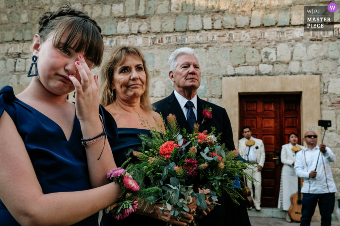 Photo by: <a href="https://www.wpja.com/contests/2019-v07/best-wedding-photographers/2502881">Nikhol Esteras - Oaxaca de Juárez Oaxaca</a> Quinta Real, Oaxaca, Mexico Wedding Day Photography | Bride and groom's daughter at the ceremony and her uncle with his selfie stick