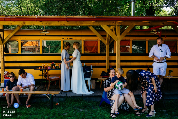 Photo by: <a href="https://www.wpja.com/contests/2019-v07/best-wedding-photographers/2505346">Leonard Walpot - Utrecht Utrecht</a> Camping de Lievelinge Wedding Photograph of little moments at the wedding day; between bride & her friend and other wedding guests.