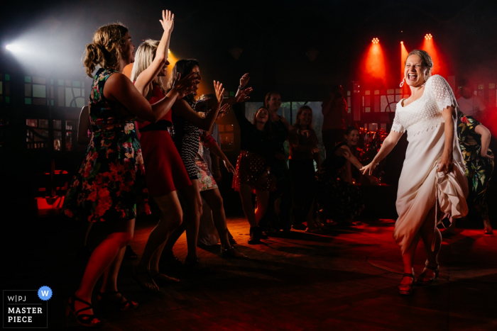 Photo by: <a href="https://www.wpja.com/contests/2019-v07/best-wedding-photographers/2505356">Leonard Walpot - Utrecht Utrecht</a> Camping de Lievelinge wedding photograph of bride and friends at the dance floor