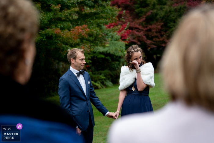 Photo by: <a href="https://www.wpja.com/contests/2019-v07/best-wedding-photographers/2505376">Carley Payne - Mooroolbark Victoria</a> Singing Gardens of CJ Dennis Wedding Photography | This is during the intimate ceremony as the celebrant was talking about the couple's love story. The bride got a bit teary so the groom took her hand.