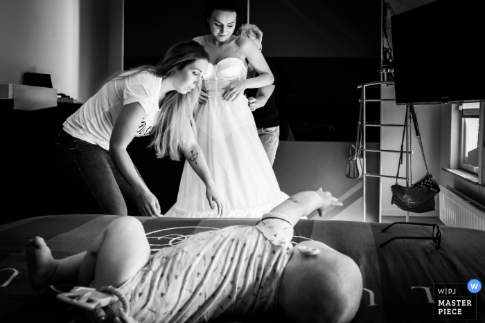 Photo by: <a href="https://www.wpja.com/contests/2019-v07/best-wedding-photographers/2505391">Caroline Elenbaas - Heijningen Noord Brabant</a> Bovendonk, Hoeven Photographer: "Getting ready, when your busy, your baby tries to catch the mothers glasses"