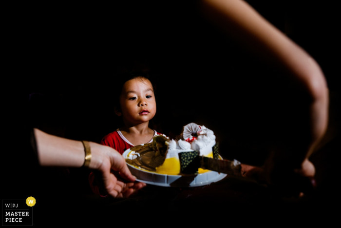 Photo by: <a href="https://www.wpja.com/contests/2019-v07/best-wedding-photographers/2505641">Joy Qin - Longyan </a> A little boy looks at the large plate of food being placed in front of him in this image captured by a Fujian, China, wedding photographer.