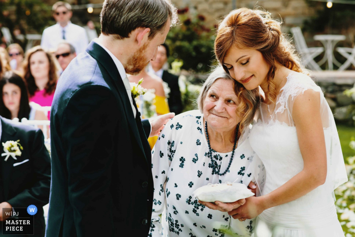Photo by: <a href="https://www.wpja.com/contests/2019-v07/best-wedding-photographers/2506726">Stefano Snaidero - Rome </a> Castello di Rosciano Wedding Ceremony Photo of the Grandmother bringing the rings outdoors