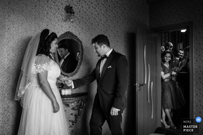 Photo by: <a href="https://www.wpja.com/contests/2019-v07/best-wedding-photographers/2507631">Ivelina Cholakova - Sofia Sofia</a> The bride and groom hold hands in the NDK in Sofia as guests watch in this black and white wedding image captured by a Bulgaria photographer.