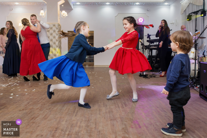 Photo by: <a href="https://www.wpja.com/contests/2019-v07/best-wedding-photographers/2507836">Wojciech Marzec - Krakow </a> Two girls dance together in Sandomierz in this wedding picture created by a Krakow documentary photographer.