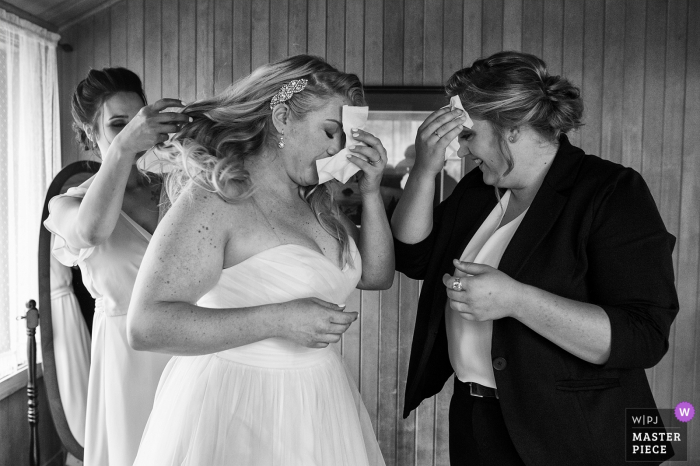 Photo by: <a href="https://www.wpja.com/contests/2019-v07/best-wedding-photographers/2507841">Tara Theilen - Carson City Nevada</a> Valhalla, South Lake Tahoe, California Black and White Wedding Photography - The bride and her daughter simultaneously wipe sweat from their brows before the ceremony.