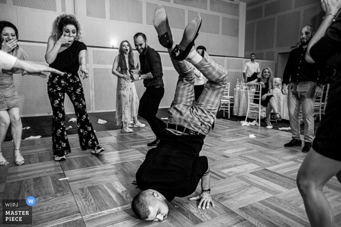 Photo by: <a href="https://www.wpja.com/contests/2019-v08/best-wedding-photographers/2509626">Mihai Zaharia - Bucharest București</a> Black and white photo of some break-dance action on the dance floor at Hotel Novotel