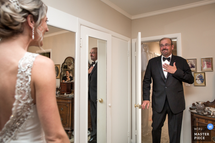 Photo by: <a href="https://www.wpja.com/contests/2019-v08/best-wedding-photographers/2510766">Lori-Anne Crewe - Ayr Ontario</a> Toronto, Ontario - The Eglinton Grand Photography - The father and bride first look. The wedding party were at the other side of the room, but you can catch one of the bridesmaids in the small mirror.