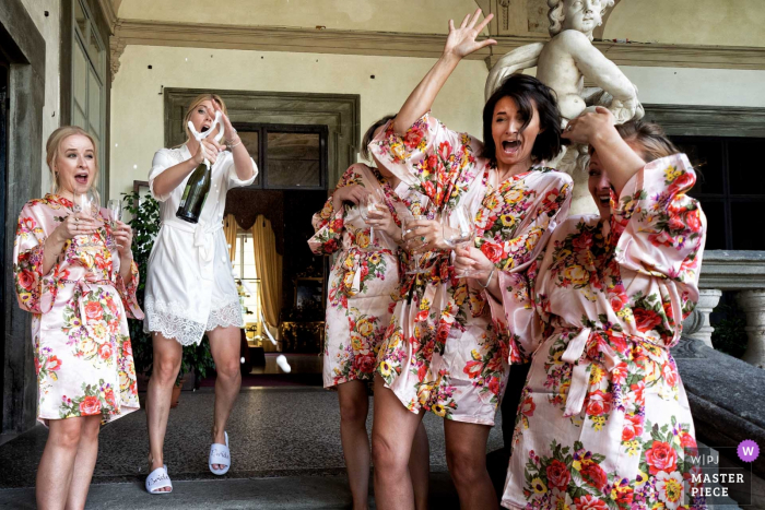 Photo by: <a href="https://www.wpja.com/contests/2019-v08/best-wedding-photographers/2512676">Alessandro Colle - Massa Massa-Carrara</a> The bride and her bridesmaids celebrate before the ceremony at Palazzo Pfanner in this photo captured by a documentary-style Tuscany wedding photographer.
