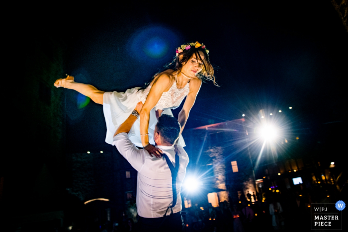 Photo by: <a href="https://www.wpja.com/contests/2019-v08/best-wedding-photographers/2513831">Andreas Pollok - Hemsbach Baden-Württemberg</a> The groom lifts the bride into the air during their first dance at Schloss Romrod in this documentary-style photo created by a Baden-Wurttemberg, Germany wedding photographer.