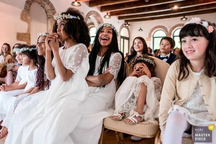 Photo by: <a href="https://www.wpja.com/contests/2019-v08/best-wedding-photographers/2514031">Sybil Rondeau - Nantes </a> Wedding photo of children laughing during ceremony at Château d'Azy