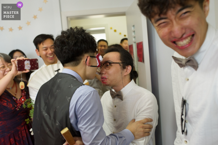 Photo by: <a href="https://www.wpja.com/contests/2019-v08/best-wedding-photographers/2515791">Andy Ren - Changsha </a> Guests laugh as two men play a game in Changsha in this documentary-style wedding picture composed by a Hunan, China photographer.