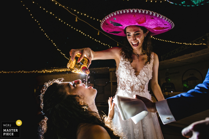 Kınalıada/İstanbul/Turkey wedding photo showing the bride and groom feeding the guests with Mexican tequila 