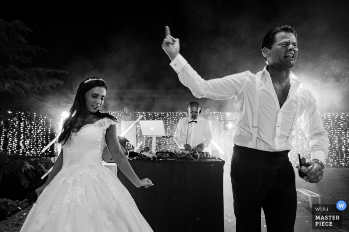 Garda Lake Italy Wedding Photograph of an exciting moment between the bride and groom during the party. 
