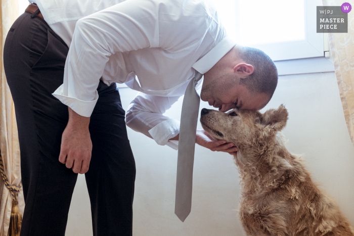 Photo by: <a href="https://www.wpja.com/contests/2019-v08/best-wedding-photographers/2518151">Valerie Teppe - Limoges </a> The groom gives his dog a hug before the ceremony in Chaptelat in this image captured by a Nouvelle-Aquitaine, France wedding photographer.