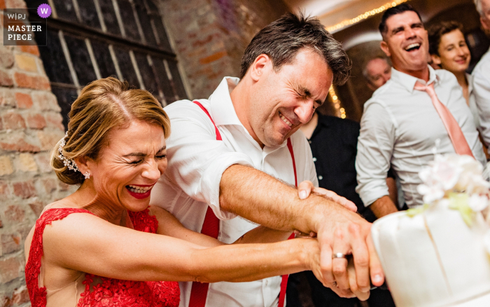 Photo by: <a href="https://www.wpja.com/contests/2019-v08/best-wedding-photographers/2518231">Tunde Koncsol - Budapest</a> Kvarda Studio Budapest Wedding Photographer - - Bride and the groom are cutting the cake.