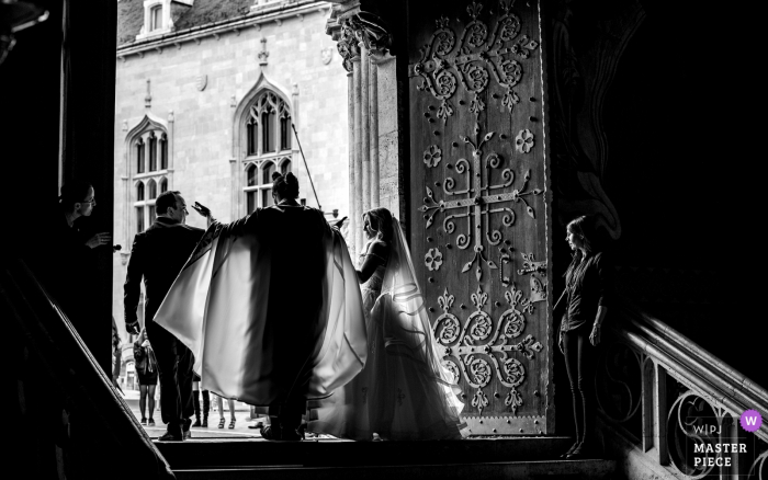 Photo by: <a href="https://www.wpja.com/contests/2019-v08/best-wedding-photographers/2518266">Tunde Koncsol - Budapest</a> Holdudvar, Casino Budapest Wedding Photo in Black and White - After the ceremony, the priest give way for the couple