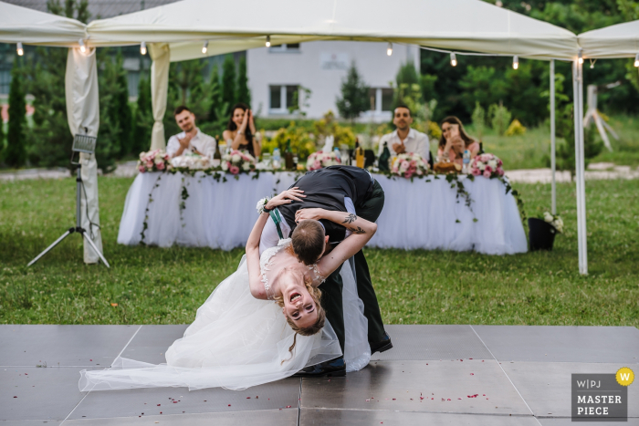 Photo by: <a href="https://www.wpja.com/contests/2019-v08/best-wedding-photographers/2518306">Ivelina Cholakova - Sofia Sofia</a> The groom dips the bride nearly down to the floor in this documentary-style photo by a Sofia, Bulgaria wedding photographer.