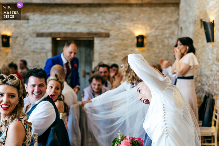 Photo by: <a href="https://www.wpja.com/contests/2019-v08/best-wedding-photographers/2518366">Jordanna Marston - Wellingborough Northamptonshire</a> Oxleaze Barn Cotswolds Wedding Venue Photographer - As couple were announced in bride's veil guest caught on chair - much shock/laughter ensued...