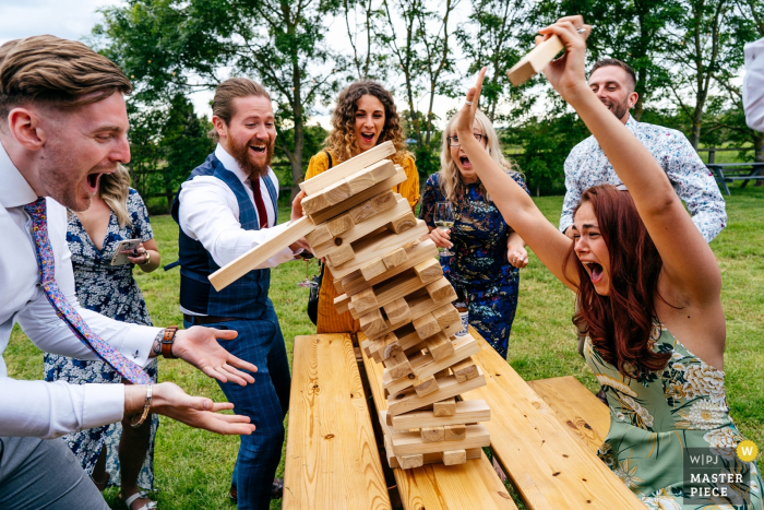 Photo by: <a href="https://www.wpja.com/contests/2019-v08/best-wedding-photographers/2518431">Jordanna Marston - Wellingborough Northamptonshire</a> Escheat Farm nr Woburn Wedding Photography - Guests enthusiastically playing Jenga