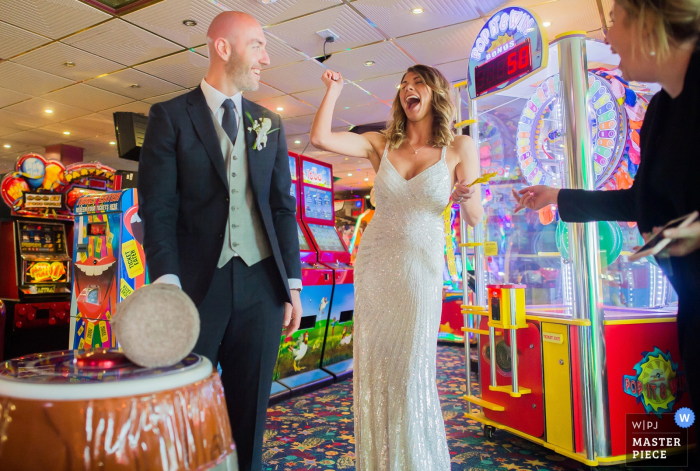 Photo by: <a href="https://www.wpja.com/contests/2019-v08/best-wedding-photographers/2518931">Gareth Williams - Exeter Devon</a> The bride and groom are ready to hit the slot machines at Ocean Kave in this award-winning photo by a Devon, England wedding photographer.