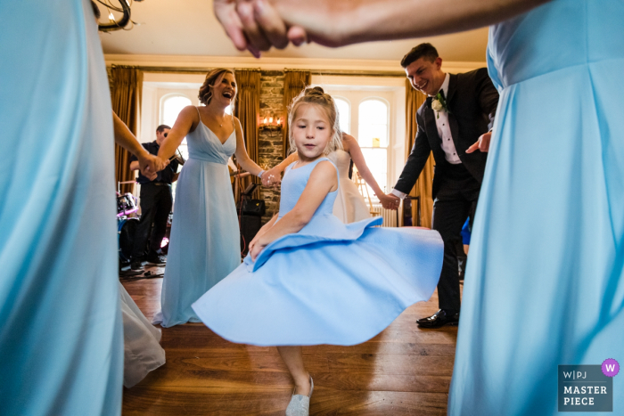 Photo by: <a href="https://www.wpja.com/contests/2019-v08/best-wedding-photographers/2519806">Annie Kheffache - Dun Laoghaire Dublin</a> Wilton Castle, Ireland Documentary Wedding Photograph showing the Flower girl dancing in circle of bridal party