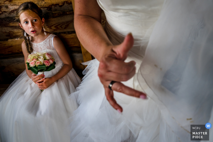 Photo by: <a href="https://www.wpja.com/contests/2019-v08/best-wedding-photographers/2520206">Nathalie Moors - Dessel Antwerpen</a> The flower girl looks in shock at the bride in Balen who accidentally got dirt on her veil in this award-winning wedding photo captured by an Antwerpen, Flanders photographer.