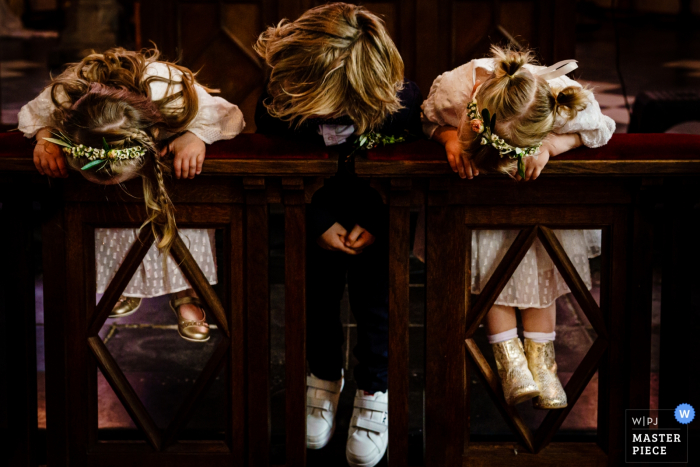 Photo by: <a href="https://www.wpja.com/contests/2019-v08/best-wedding-photographers/2520226">Nathalie Moors - Dessel Antwerpen</a> Three children stand on and peer over a banister at Serre Van Gorp in this award-winning photo captured by an Antwerpen, Flanders wedding photographer.
