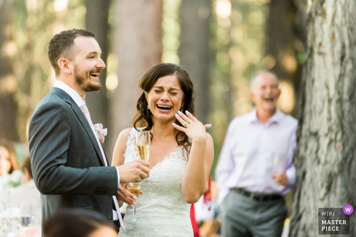 Photo by: <a href="https://www.wpja.com/contests/2019-v09/best-wedding-photographers/2527531">Lauren Lindley - South Lake Tahoe California</a> Private Estate - Meyers, CA Wedding Photography - A bride and groom listen to their loved ones toast them at their wedding reception.