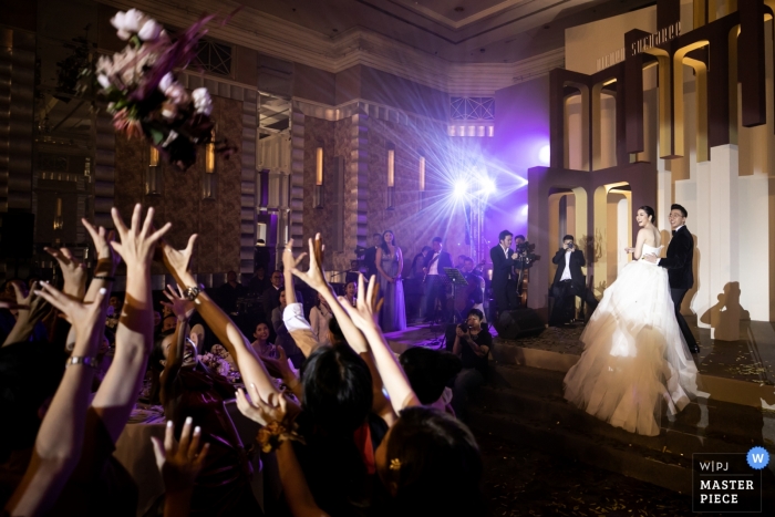 Photo by: <a href="https://www.wpja.com/contests/2019-v09/best-wedding-photographers/2531436">Chaiyasith Junjuerdee - Fulham London</a> InterContinental Bangkok wedding reception of the bride throwing her bouquet out to her guests.