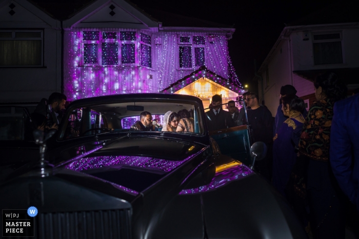 Photo by: <a href="https://www.wpja.com/contests/2019-v09/best-wedding-photographers/2532106">Jay Hoque - Uxbridge London</a> Newbury Racecourse, UK Wedding Reportage - Saying goodbye from bride and groom get away car after reception.