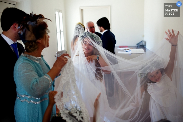 children playing in the veil of the bride Portugal wedding photo of children playing in the veil of the bride.