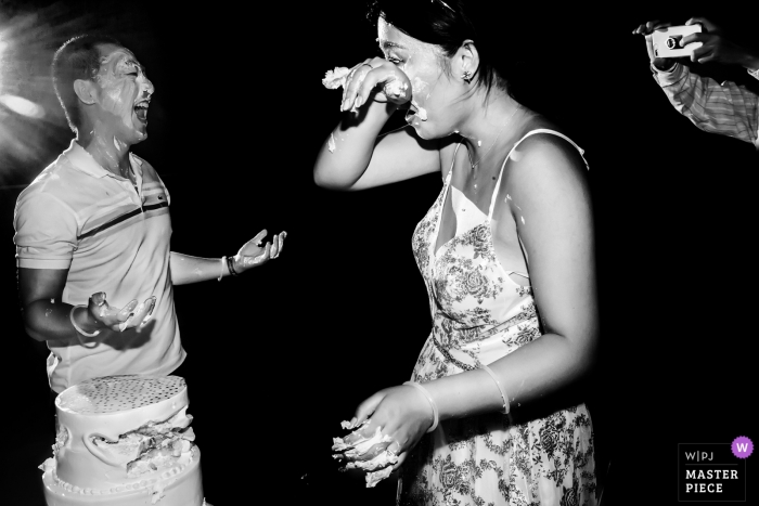 Photo by: <a href="https://www.wpja.com/contests/2019-v09/best-wedding-photographers/2533276">Vincent Mu - De Zhou </a> Cancun, Mexico - Photo of cake smash - After party wedding fun