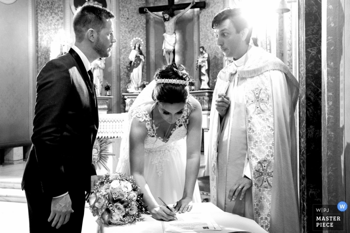 Photo by: <a href="https://www.wpja.com/contests/2019-v09/best-wedding-photographers/2534151">Willian Mariot - Urussanga Santa Catarina</a> A moment of signatures after the wedding ceremony at Igreja Matriz Nossa Senhora da Conceição where the priest looked at the bridegroom and said something.