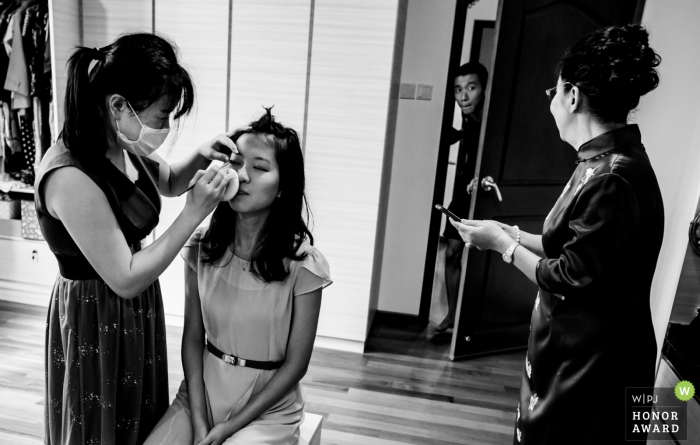 Asking mum where his tie is Singapore wedding photo during getting ready | Asking mum where his tie is
