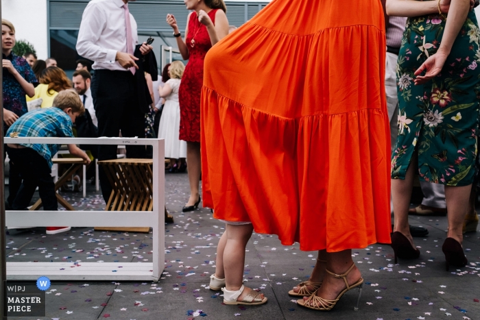 Photo by: <a href="https://www.wpja.com/contests/2019-v09/best-wedding-photographers/2537091">Kristian Leven - London</a> Guildford Harbour Hotel Wedding Venue Photos - A flowergirl hides in her mum's dress