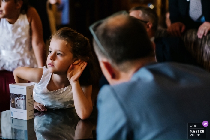Photo by: <a href="https://www.wpja.com/contests/2019-v09/best-wedding-photographers/2537116">Kristian Leven - London</a> Warren House Wedding Reception Photography | A flowergirl requests that a guest should speak up