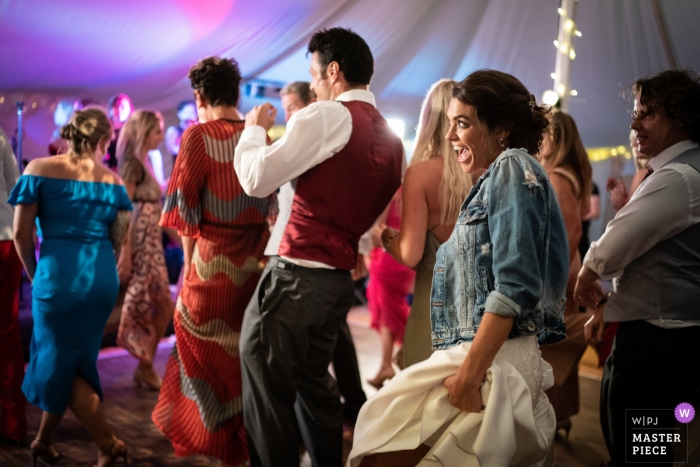 Photo by: <a href="https://www.wpja.com/contests/2019-v09/best-wedding-photographers/2537356">Harry Richards - Islington London</a> Merton Grange, Dorset Wedding Reception Photos - Bride breaks the line dance
