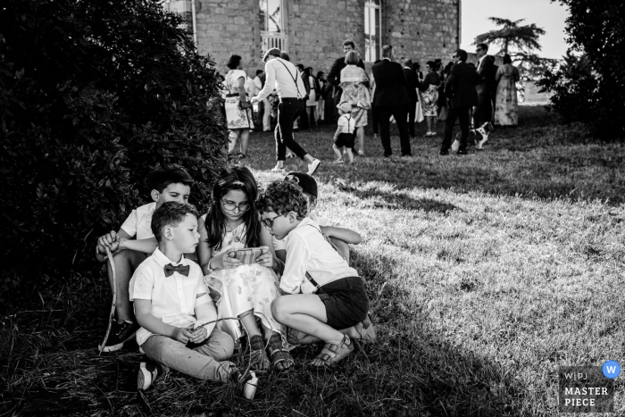 Photo by: <a href="https://www.wpja.com/contests/2019-v09/best-wedding-photographers/2538006">Florent Cattelain - Labarthe-sur-Lèze </a> Chateau de Tauzies, Gaillac, France Weddings - Children on electronic devices at wedding reception