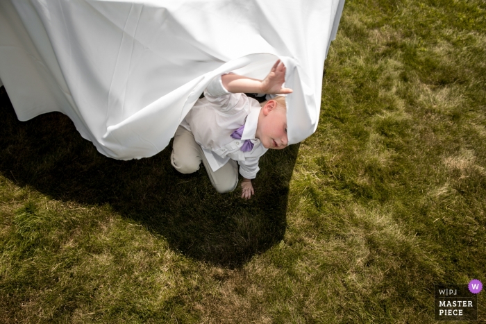 Photo by: <a href="https://www.wpja.com/contests/2019-v09/best-wedding-photographers/2538131">Lori-Anne Crewe - Ayr Ontario</a> Strathroy, Ontario, Canada Wedding Venue - Photo showing Playing under the reception tables.