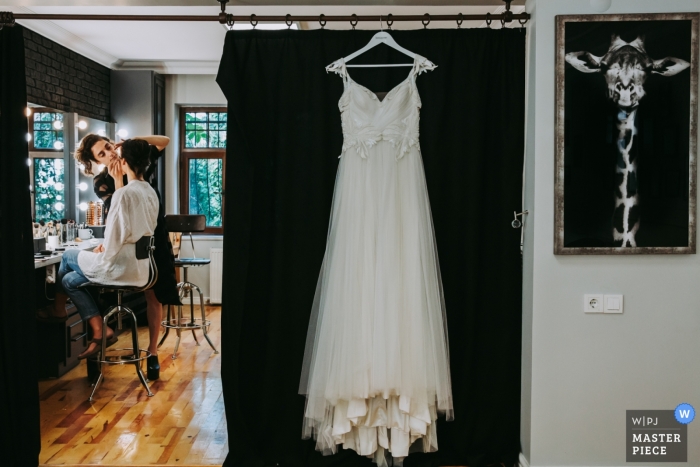 Photo by: <a href="https://www.wpja.com/contests/2019-v09/best-wedding-photographers/2539241">Serenay Lokcetin - Antalya</a> stanbul-GreenPark Photography - Bride Make Up and Dress hanging on wedding day.