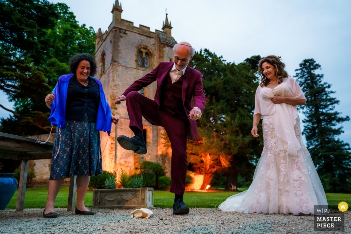 Photo by: <a href="https://www.wpja.com/contests/2019-v09-photography-competition/best-wedding-photographers/2540141">Alex Bradbury - Leamington Spa Warwickshire</a> Ettington Park Hotel Wedding Venue Photography - The groom stamping on the glass at the end of their Jewish blessing