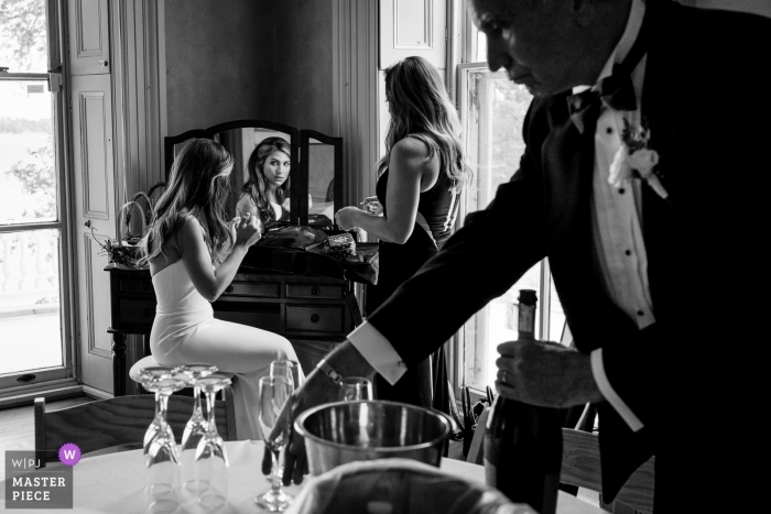 Photo by: <a href="https://www.wpja.com/contests/2019-v09/best-wedding-photographers/2540606">JD Land - Marlton New Jersey</a> Glen Foerd Wedding Photography showing the Bride finishing getting ready while her Father prepares a toast