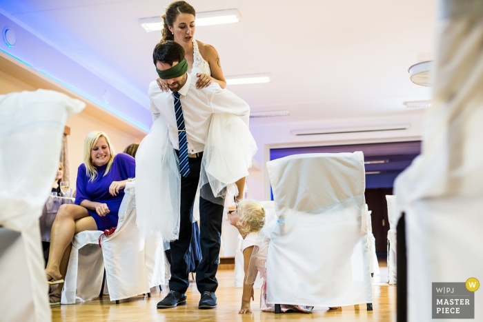 Photo by: <a href="https://www.wpja.com/contests/2019-v09/best-wedding-photographers/2540976">Matouš Bárta - Prague </a> Váňův statek wedding photojournalism - Spectators of the piggyback ride game