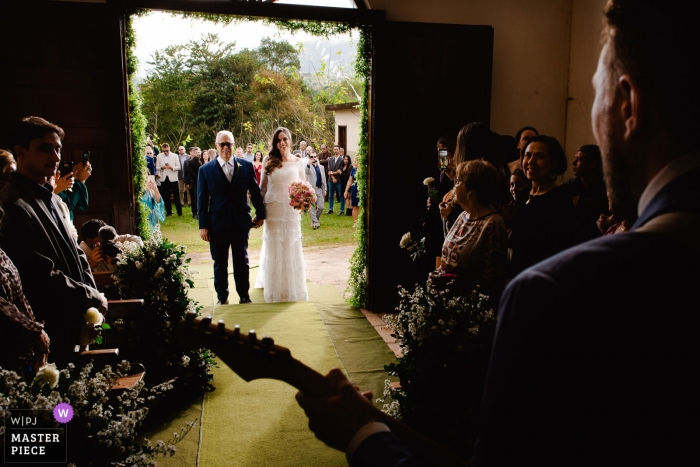 Photo by: <a href="https://www.wpja.com/contests/2019-v09/best-wedding-photographers/2541001">Vinicius Terror - Ouro Preto Minas Gerais</a> Igreja de Fátima Documentary Wedding Photography of the Bride entering building with live music