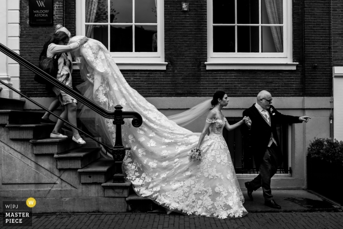Photo by: <a href="https://www.wpja.com/contests/2019-v09/best-wedding-photographers/2541671">Isabelle Hattink - Rotterdam Zuid Holland</a> Bride with father on the way to the ceremony at De Krijtberg - Amsterdam - Wedding Photography