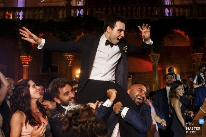 Photo by: <a href="https://www.wpja.com/contests/2019-v10/best-wedding-photographers/2542815">Ufuk Sarisen - Istanbul</a> Wedding photo of the groom being lifted on the dance floor during a reception at Sursock Palace in Beirut.