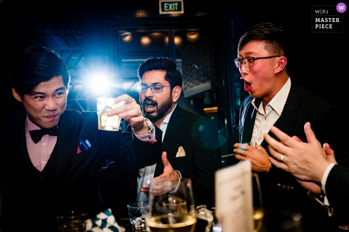 Photo by: <a href="https://www.wpja.com/contests/2019-v10/best-wedding-photographers/2543421">Vu Nguyen - Ho Chi Minh </a> A groom enjoys some time with his friends drinking wine at the Swan Restaurant.